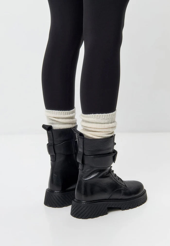 Stay warm and stylish this winter with these black lace-up boots featuring a Betty wool insole for extra comfort. These rugged winter boots are perfect for outdoor adventures.