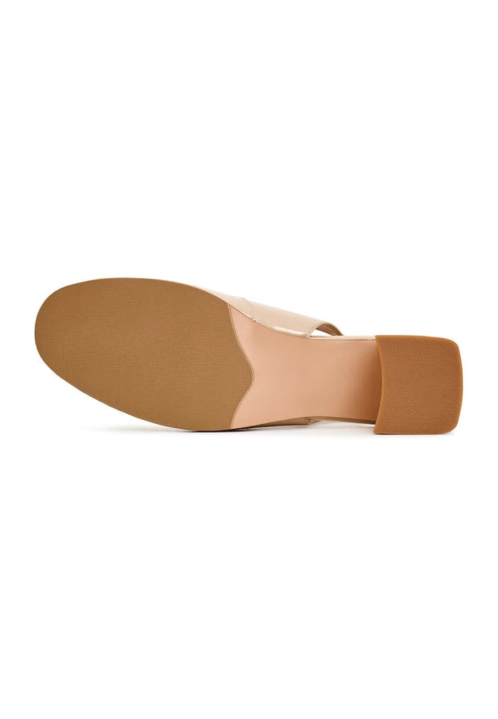 A close-up image of chic beige slingback pumps, Nina heels for women - the perfect pair of fashionable dress shoes for any occasion.