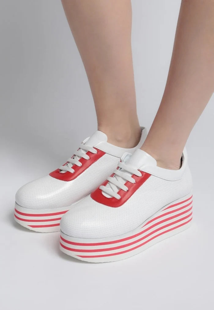A trendy pair of red high platform sneakers with striped design, ideal for a bold and stylish look.