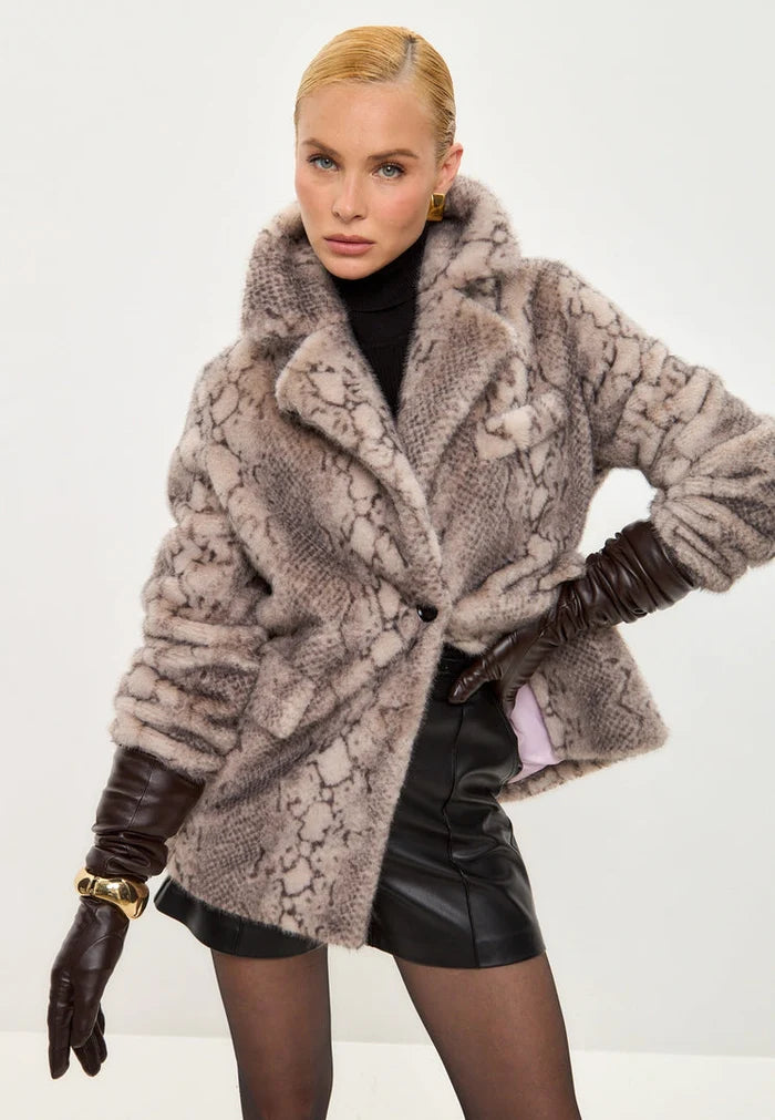 A trendy winter fashion statement featuring a stylish beige faux fur snake print Niuvis coat as chic outerwear.
