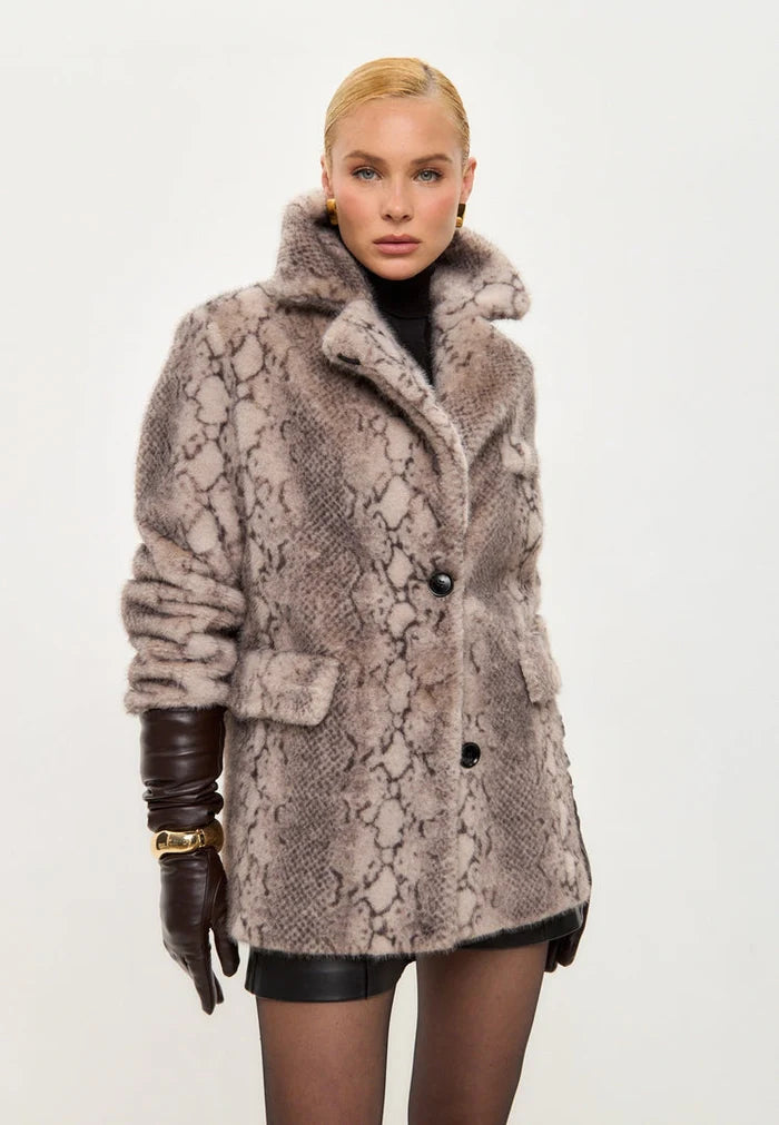 A trendy winter fashion statement with a stylish snake print Niuvis coat in beige faux fur, perfect for staying chic and cozy this season.