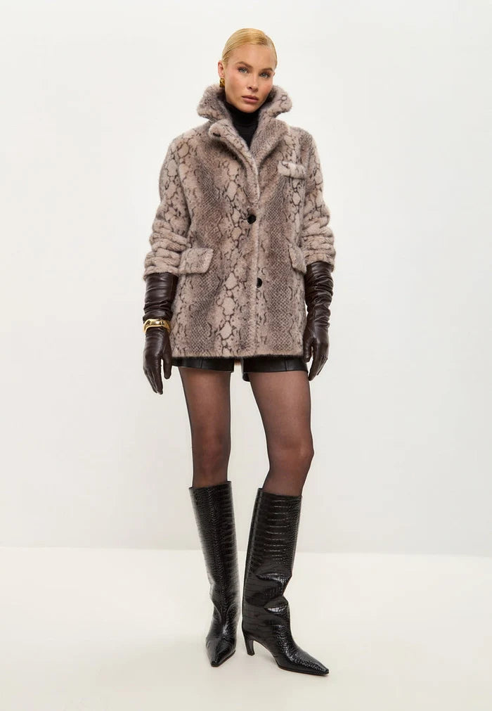 A stylish Niuvis snake print coat in beige faux fur, the perfect trendy winter fashion outerwear.