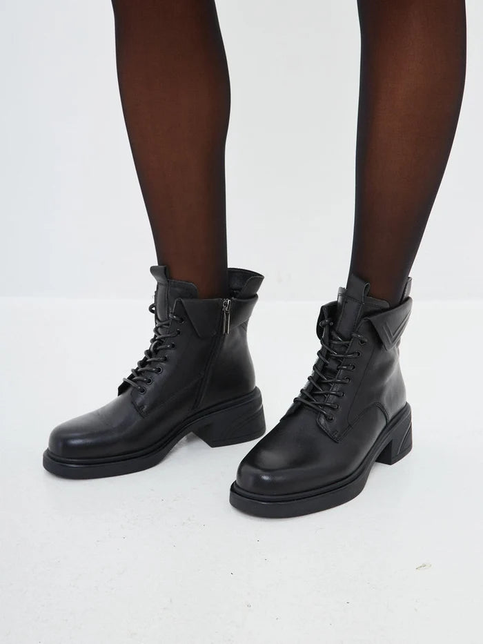 A chic pair of stylish black ankle boots with a trendy block heel, perfect for any fashionable outfit.