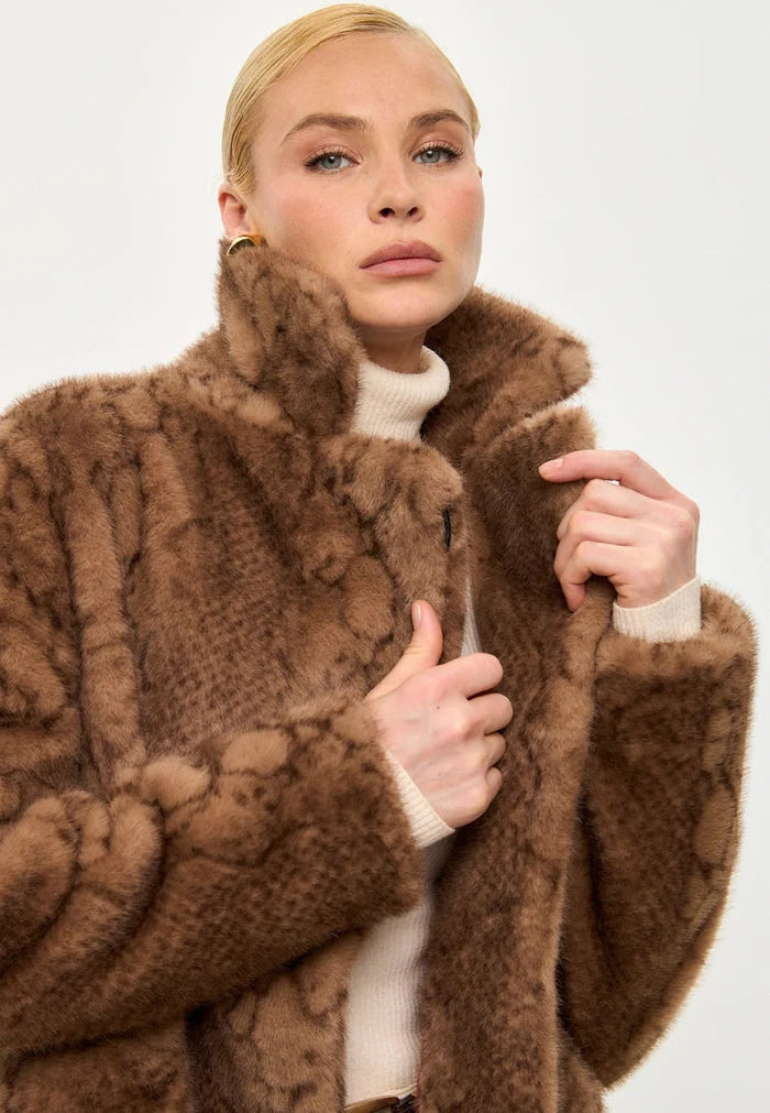 A trendy brown faux fur coat with snake print design by Niuvis, a stylish and trendy outerwear option.