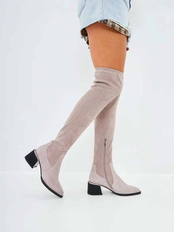 A pair of stylish beige suede over-the-knee boots - the epitome of chic fashion footwear.