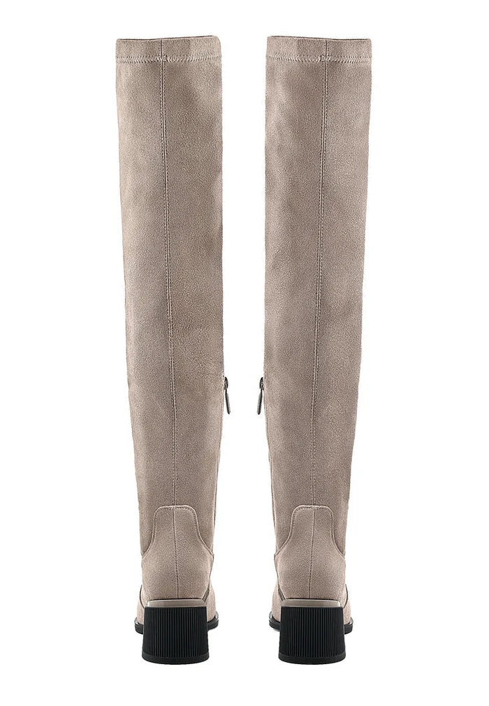 A pair of fashionable beige suede over-the-knee boots, the perfect chic footwear for any outfit.