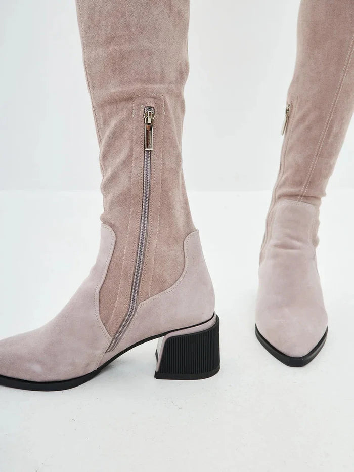 A stylish pair of beige suede over-the-knee boots, a must-have for chic and trendy fashion footwear.