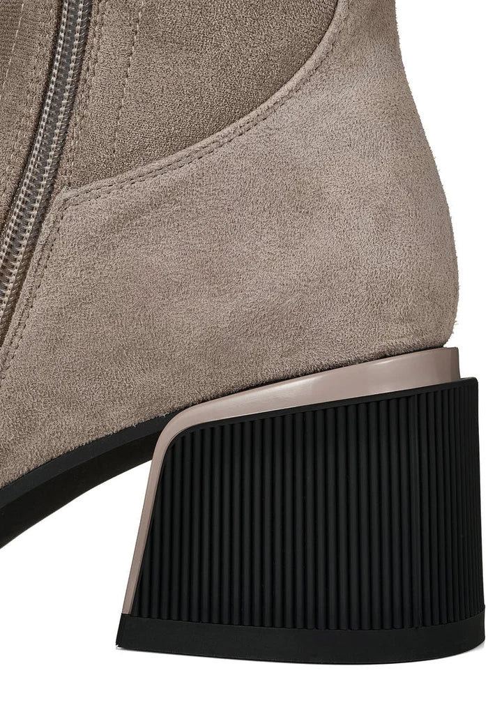A stylish pair of beige suede over-the-knee boots, the epitome of chic fashion footwear.