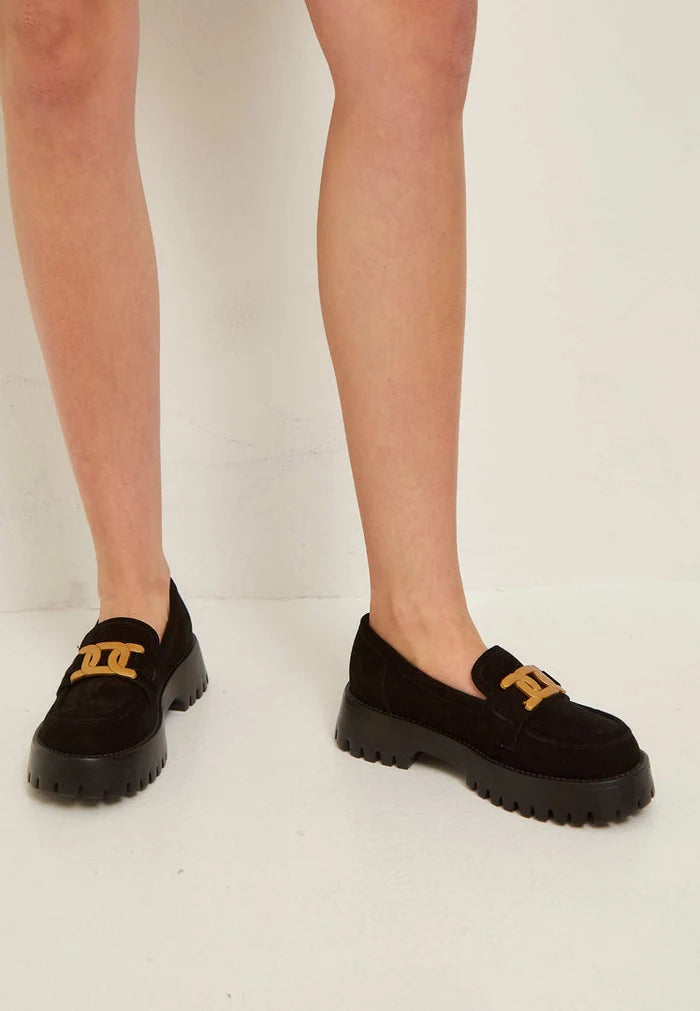 A trendy pair of chunky suede black loafers with a golden chain accent - stylish footwear for any outfit.