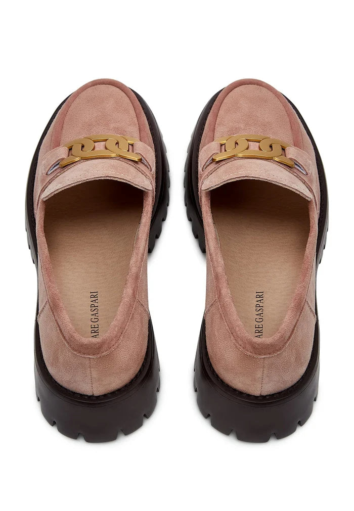 A pair of stylish chunky suede pink loafers adorned with a golden chain for women's fashion.