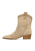 A stylish pair of designer suede cowboy boots in beige, embodying a classic Western style with genuine leather craftsmanship.