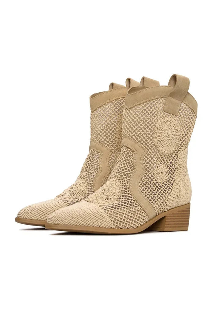 A pair of stylish suede cowboy boots in beige color with a western design, perfect for those who love designer leather cowboy boots.
