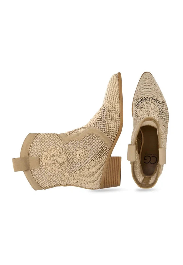 A stylish pair of designer suede cowboy boots in a beautiful beige color, featuring classic western style and crafted from high-quality leather.