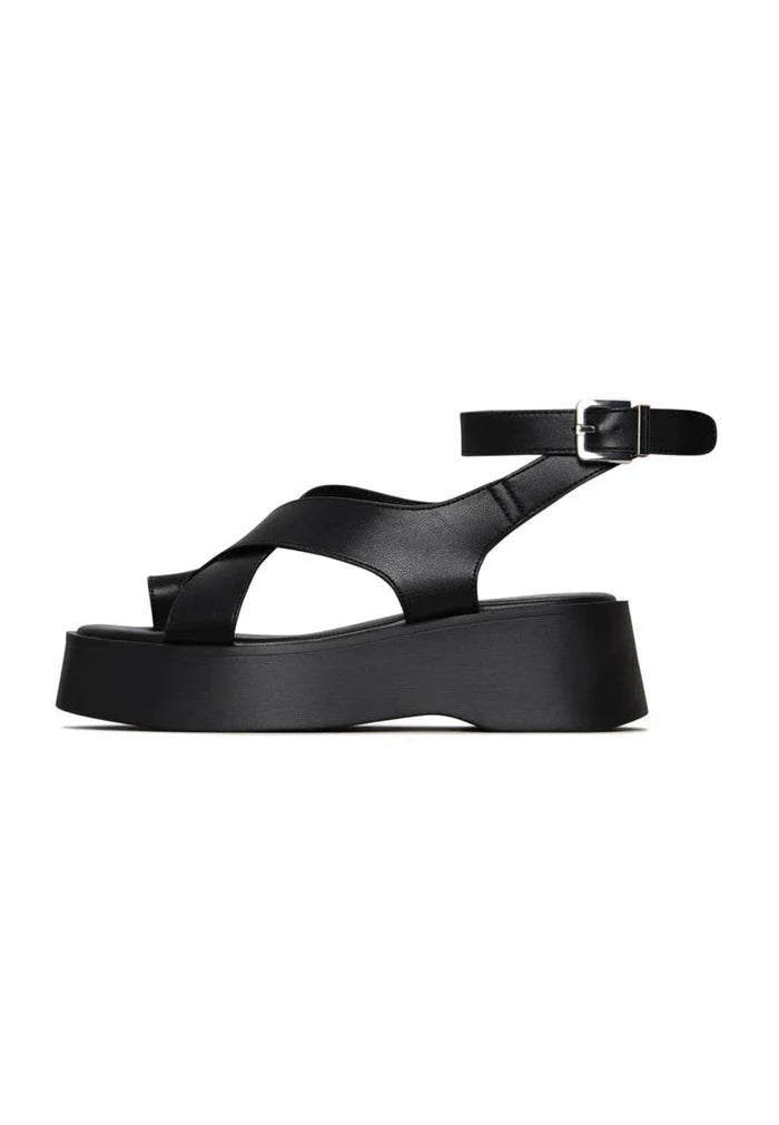A trendy pair of women's black suede cross-strap sandals, perfect for summer with a stylish strappy design.