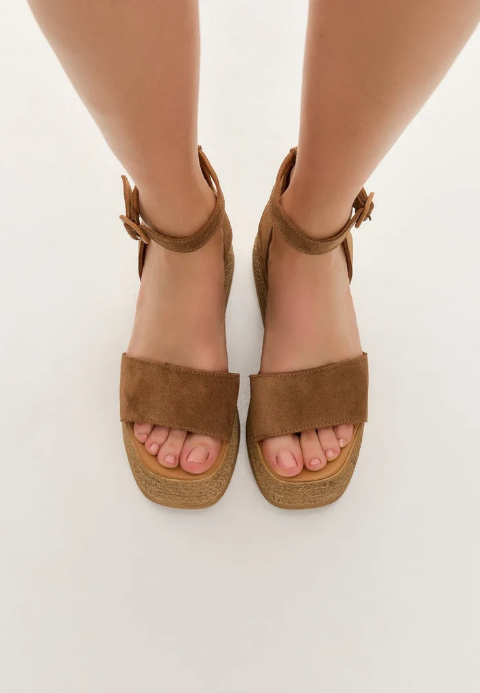 A stylish pair of women's bronze platform sandals made of soft suede, perfect for a trendy and fashionable look.