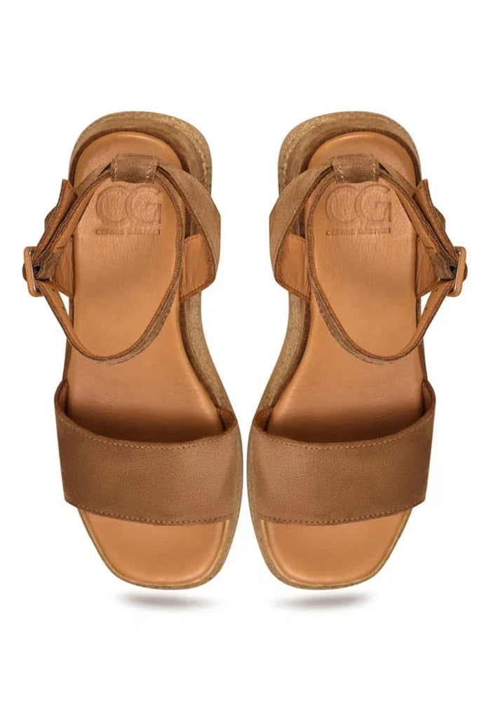 A stylish pair of women's bronze platform sandals in trendy suede material.