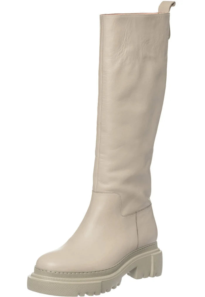 A trendy pair of tall leather chunky sole beige boots for women, perfect for those looking for a fashionable footwear option.