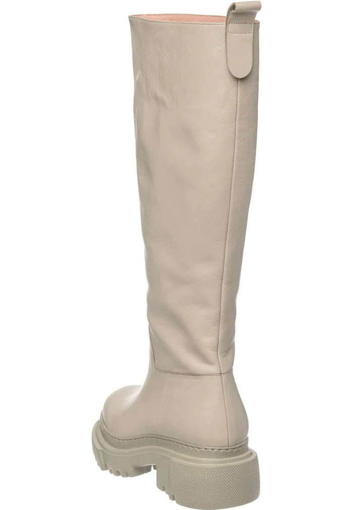 A pair of stylish tall leather chunky sole beige boots for women, the perfect fashion footwear choice.