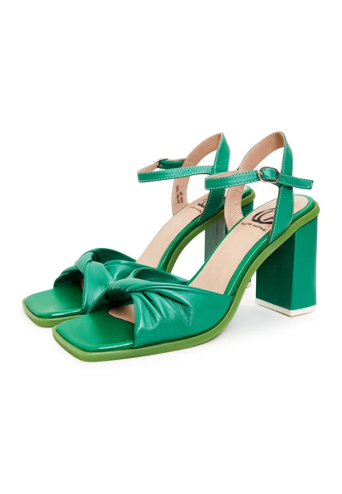 A pair of elegant green block heels, a timeless and stylish choice for classic footwear.