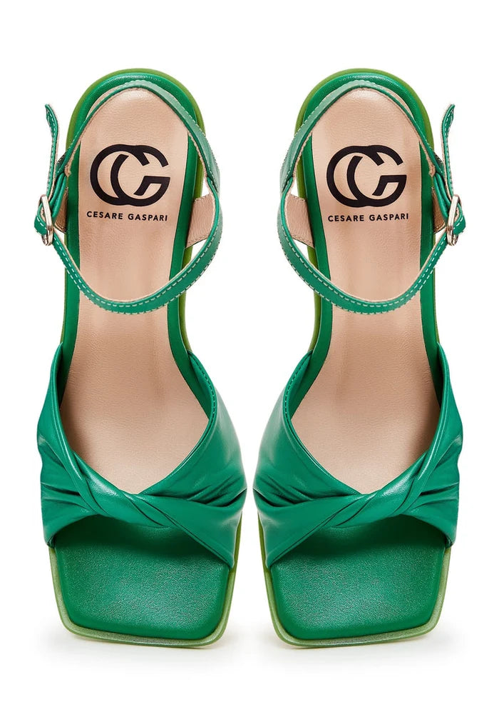 A pair of elegant green block heels, a timeless and stylish choice for classic footwear fashion.