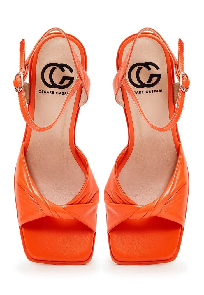 A stylish pair of women's block heels in a timeless orange hue, showcasing classic style in women's footwear fashion.