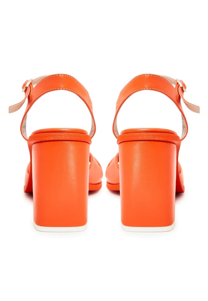 A chic pair of women's orange block heels, exuding timeless fashion and classic style.