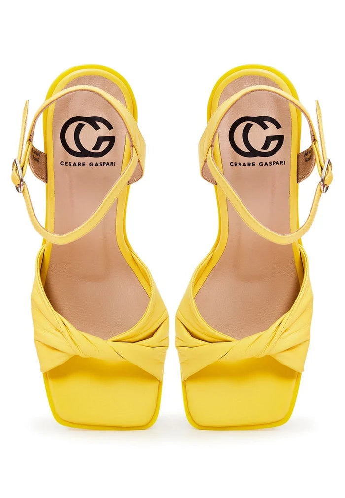 Elevate your style with these fashionable yellow block heels - timeless footwear for the modern woman.