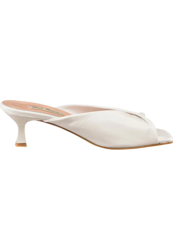 A close-up image of stylish white twist luxe high heels with a chic twist design, perfect for a fashionable outfit.