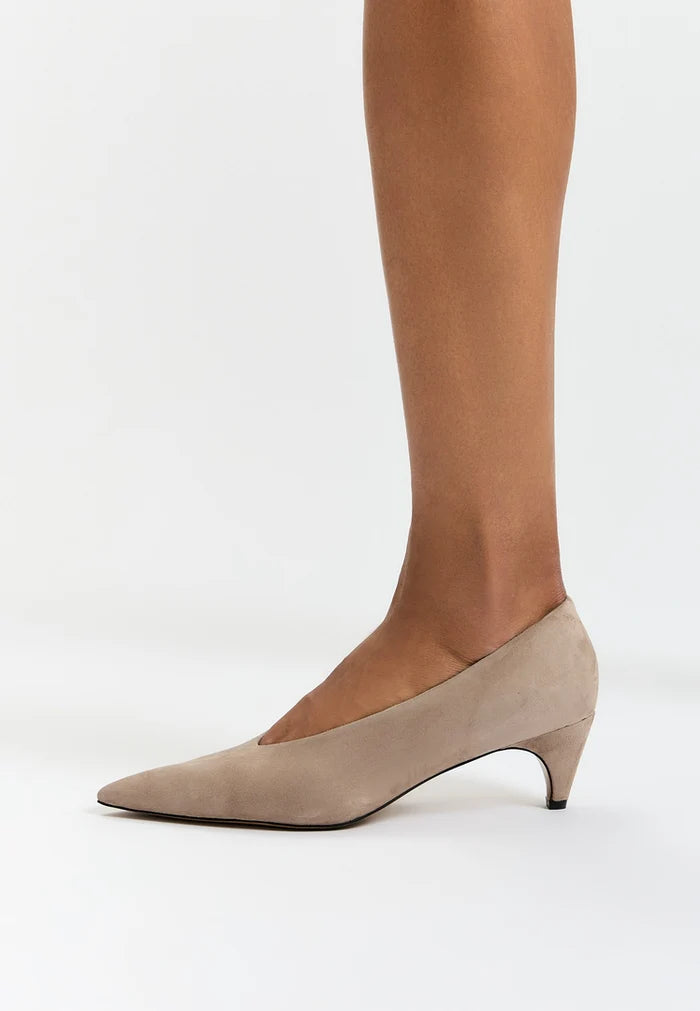 A stylish pair of beige curve pumps - the perfect women's heels for fashion-forward individuals. These designer pumps are a must-have in any fashion footwear collection.