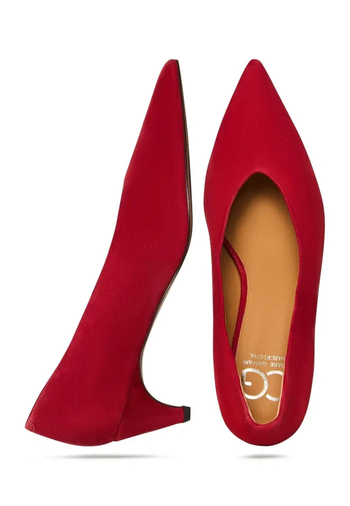 A pair of elegant red velvet pumps, perfect for a night out or special occasion, featuring a curve design and high heels for women.
