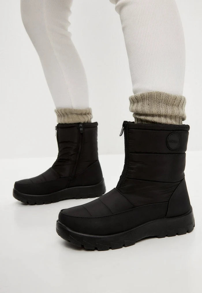 Stay warm and cozy this winter with waterproof insulated snow boots featuring fur lining and snow grips for extra traction.