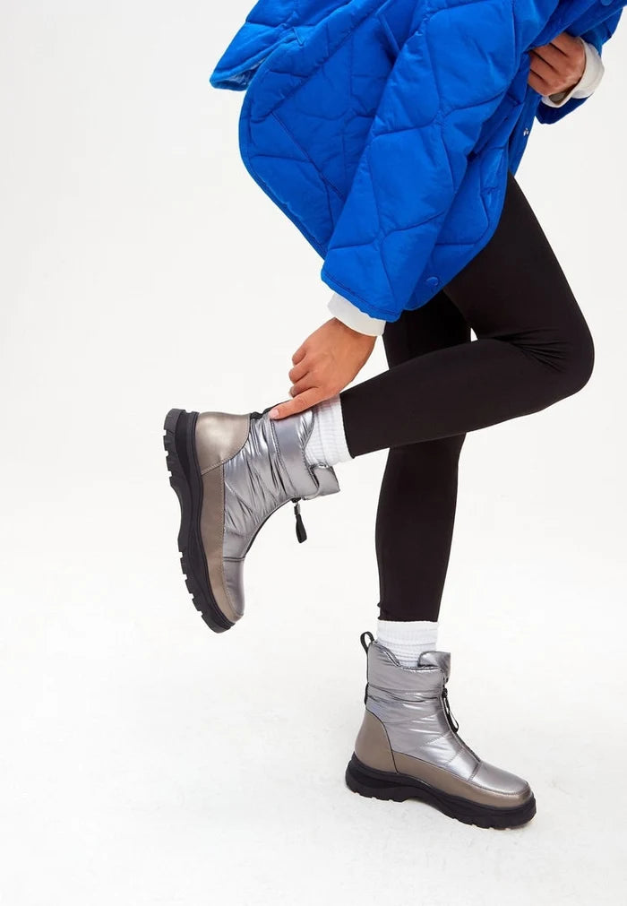 A pair of stylish silver insulated winter boots, perfect for keeping your feet warm and dry in cold weather and snowy conditions.