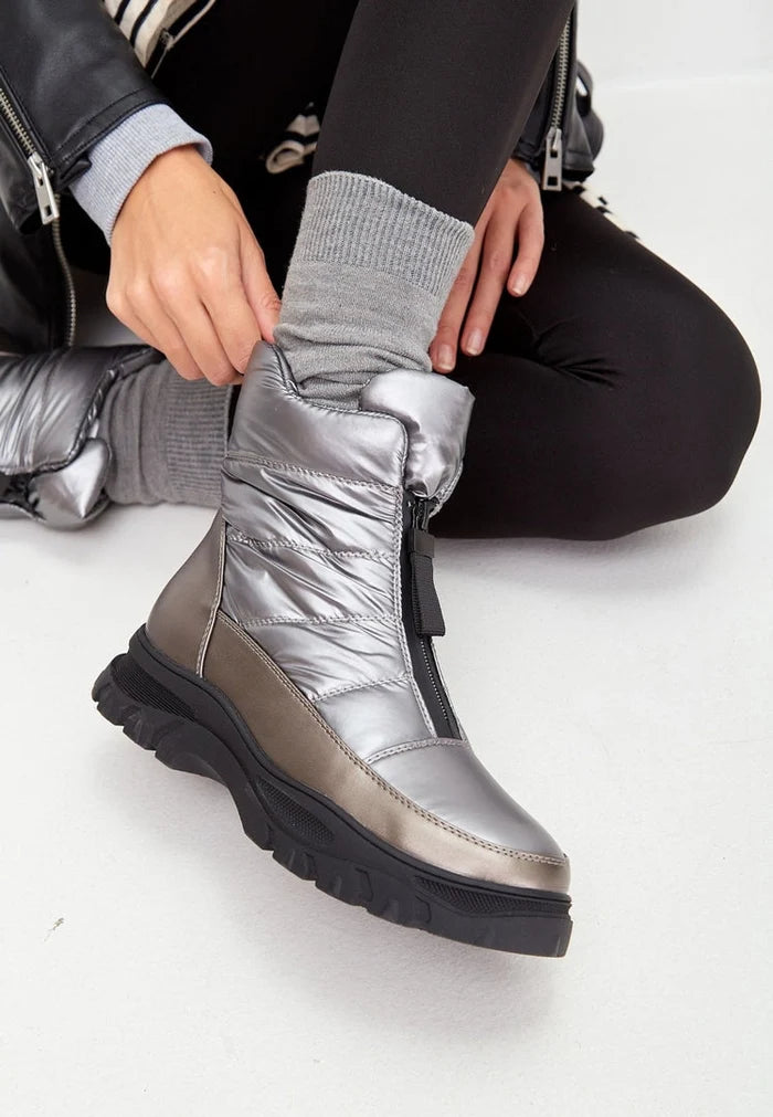 A pair of stylish silver insulated winter boots for cold weather and snowy days.